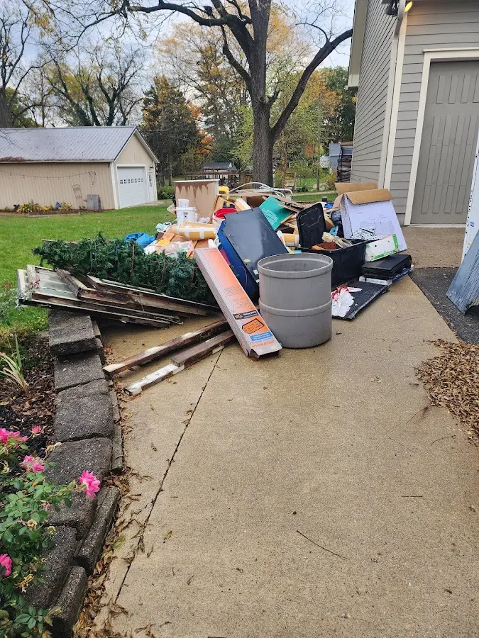 Dumpster being loaded with debris for Estate Cleanout Dumpster Rental in Waconia